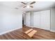 Spacious bedroom with wood-look floors, ceiling fan and access to another room at 6941 Twilite Dr, Port Richey, FL 34668