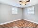 Bright bedroom featuring wood-look floors and ceiling fan at 6941 Twilite Dr, Port Richey, FL 34668