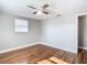 Bright bedroom with wood-look floors and ceiling fan at 6941 Twilite Dr, Port Richey, FL 34668