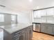 Kitchen island with granite countertop and gray cabinets at 6941 Twilite Dr, Port Richey, FL 34668