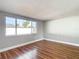 Living room with hardwood floors and large window at 6941 Twilite Dr, Port Richey, FL 34668