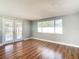 Bright living room with hardwood floors and sliding doors to patio at 6941 Twilite Dr, Port Richey, FL 34668