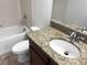 Clean bathroom with granite countertop, white sink, and bathtub at 16617 Magnolia Reserve Pl, Wimauma, FL 33598