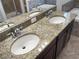 Double vanity bathroom with granite countertop and oval sinks at 16617 Magnolia Reserve Pl, Wimauma, FL 33598