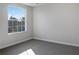 Bedroom with large window and carpet flooring at 16617 Magnolia Reserve Pl, Wimauma, FL 33598