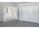 Bedroom with double door closet and carpet flooring at 16617 Magnolia Reserve Pl, Wimauma, FL 33598