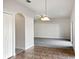 Bright dining room with tile flooring and an arched doorway at 16617 Magnolia Reserve Pl, Wimauma, FL 33598