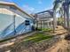 Side yard with partial grass and brick at 2956 Laurel Ct, Dunedin, FL 34698