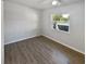 Simple bedroom with hardwood floors and window at 2956 Laurel Ct, Dunedin, FL 34698