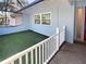 Enclosed patio area with artificial turf and white railing at 2956 Laurel Ct, Dunedin, FL 34698