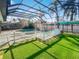 Screened pool and spa area with artificial turf at 2956 Laurel Ct, Dunedin, FL 34698