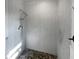 Spa-like shower with pebble floor and modern fixtures at 2956 Laurel Ct, Dunedin, FL 34698