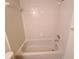 Clean bathroom with tub and tile surround at 4034 Dream Oak Pl # 104, Tampa, FL 33613