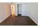 Simple carpeted bedroom with a closet and an adjacent hallway at 4034 Dream Oak Pl # 104, Tampa, FL 33613