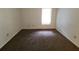 Spacious carpeted bedroom with a window and neutral walls at 4034 Dream Oak Pl # 104, Tampa, FL 33613