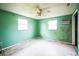 Empty bedroom with green walls and ceiling fan at 4119 Beacon Square Dr, Holiday, FL 34691