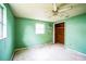 Empty bedroom with green walls, ceiling fan, and wood closet at 4119 Beacon Square Dr, Holiday, FL 34691