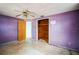 Empty bedroom with purple walls and a wood closet at 4119 Beacon Square Dr, Holiday, FL 34691