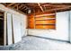 Unfinished garage with wooden shelving and door at 4119 Beacon Square Dr, Holiday, FL 34691