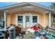 Front view of a single-story house needing repairs, with cluttered porch at 4119 Beacon Square Dr, Holiday, FL 34691