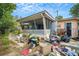 Backyard view with cluttered patio and screened porch at 4119 Beacon Square Dr, Holiday, FL 34691