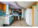 Small kitchen with blue and orange cabinets needing renovation at 4119 Beacon Square Dr, Holiday, FL 34691