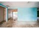 Empty living room with light blue walls and dirty floors at 4119 Beacon Square Dr, Holiday, FL 34691