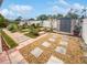 Landscaped backyard with a shed and patio area at 1414 Wickham Ln, Holiday, FL 34691