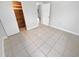 Spacious bedroom with tile flooring and a large closet at 1414 Wickham Ln, Holiday, FL 34691
