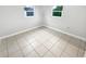 Simple bedroom with tile floors and neutral walls at 1414 Wickham Ln, Holiday, FL 34691