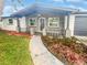 House exterior with a landscaped walkway at 1414 Wickham Ln, Holiday, FL 34691