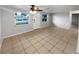 Living room with tile floors and ceiling fan at 1414 Wickham Ln, Holiday, FL 34691