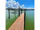 Wooden dock with boat lift in calm water at 514 Boca Ciega Point N Blvd, St Petersburg, FL 33708
