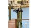 Wooden dock with bird on post over water at 514 Boca Ciega Point N Blvd, St Petersburg, FL 33708