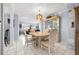 Dining area with a light wood table and glass-front hutch at 11095 56Th N Ave, Seminole, FL 33772