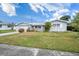 Ranch style home with a well-maintained lawn and attached garage at 11095 56Th N Ave, Seminole, FL 33772