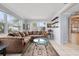 Living area features sectional sofa, coffee table, and built-in shelving at 11095 56Th N Ave, Seminole, FL 33772