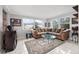 Living room with sectional sofa, coffee table, and large windows at 11095 56Th N Ave, Seminole, FL 33772