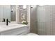 Clean bathroom with white vanity and grey tile shower at 14451 Coastal Woodland Ln, Parrish, FL 34219
