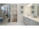 Elegant bathroom with double vanity, large walk-in shower, and separate tub at 14451 Coastal Woodland Ln, Parrish, FL 34219