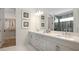 Spa-like bathroom with double vanity, walk-in shower, and soaking tub at 14451 Coastal Woodland Ln, Parrish, FL 34219