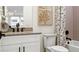 Modern bathroom with white cabinets and a herringbone tile shower at 14451 Coastal Woodland Ln, Parrish, FL 34219