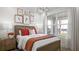 Cozy bedroom with wood bed frame and plenty of natural light at 14451 Coastal Woodland Ln, Parrish, FL 34219