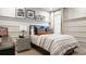 Cozy bedroom with a newspaper-themed wall and comfortable bedding at 14451 Coastal Woodland Ln, Parrish, FL 34219