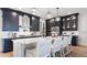 Gourmet kitchen boasts an expansive island and dark cabinetry at 14451 Coastal Woodland Ln, Parrish, FL 34219