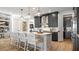 Open kitchen with island, stainless steel appliances, and dark cabinetry at 14451 Coastal Woodland Ln, Parrish, FL 34219