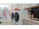 Bright laundry room with washer, dryer and storage at 14451 Coastal Woodland Ln, Parrish, FL 34219