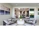 Relaxing outdoor patio with seating and views into the home at 14451 Coastal Woodland Ln, Parrish, FL 34219