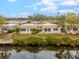 Aerial view of canal-front home with private dock and lush landscaping at 2322 Riverbluff Pkwy # V250, Sarasota, FL 34231