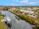 Aerial view of canal-front property with boat at 2322 Riverbluff Pkwy # V250, Sarasota, FL 34231